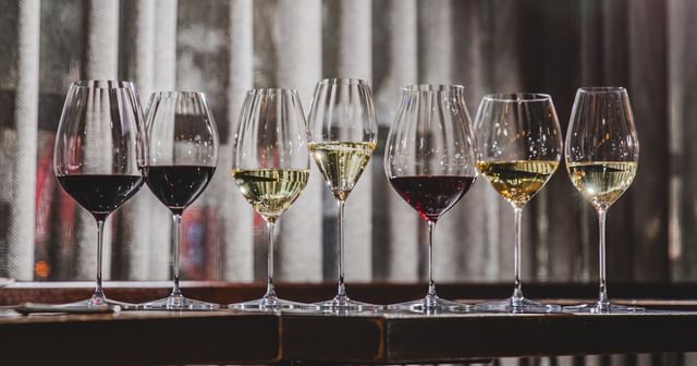 RIEDEL Performance collection on a table top filled with wines.