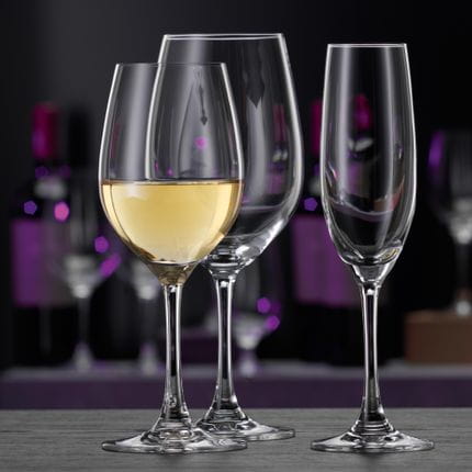 The SPIEGELAU Winelovers crystal glass collection, starting from left with an empty white wine glass, a filled white wine glass, an empty Bordeaux glass, an empty Champagne glass and an empty beer or water glass.<br/>
